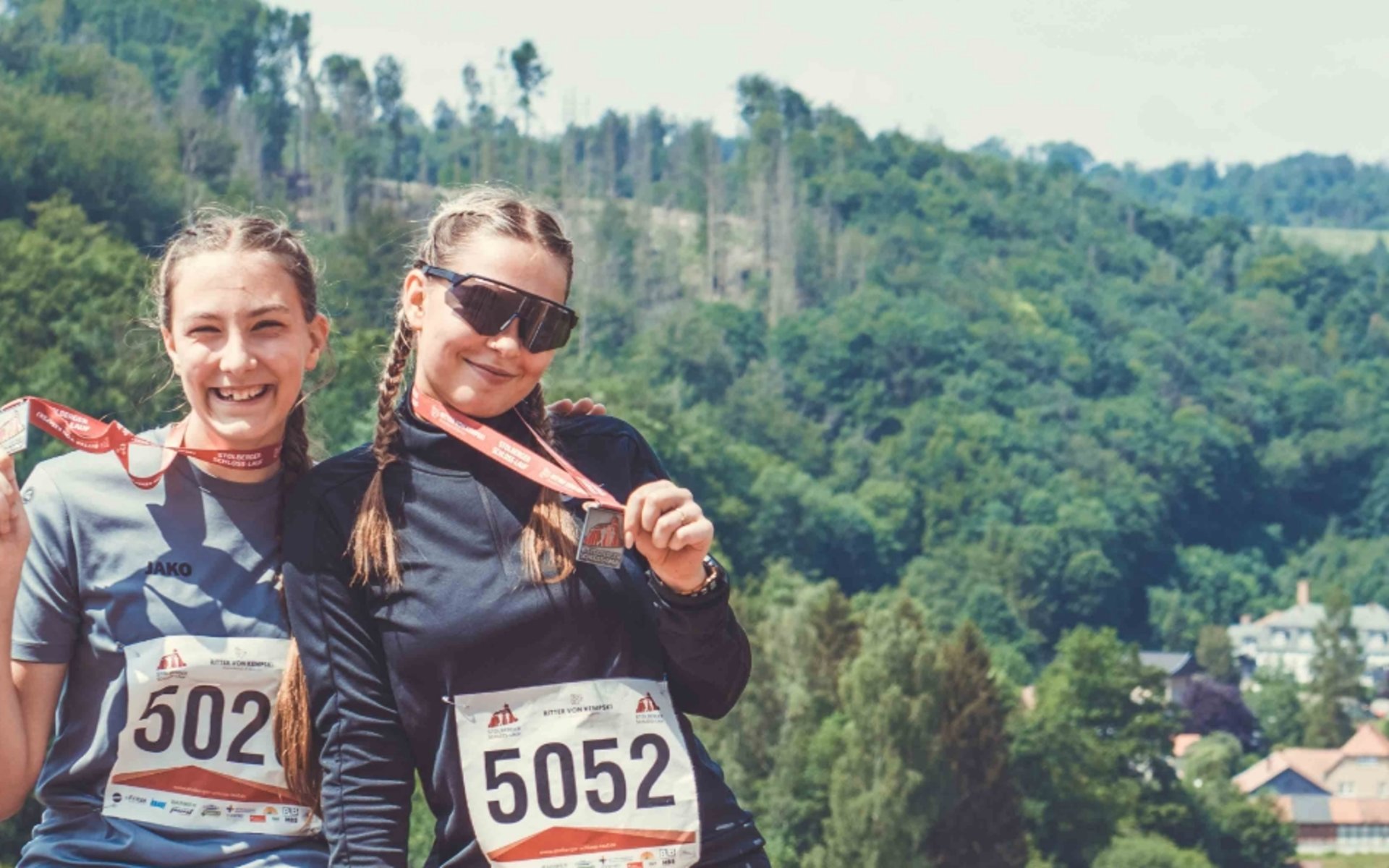 Two female runners win medals at the Stolberg Castle Run in Stolberg in the Harz Mountains